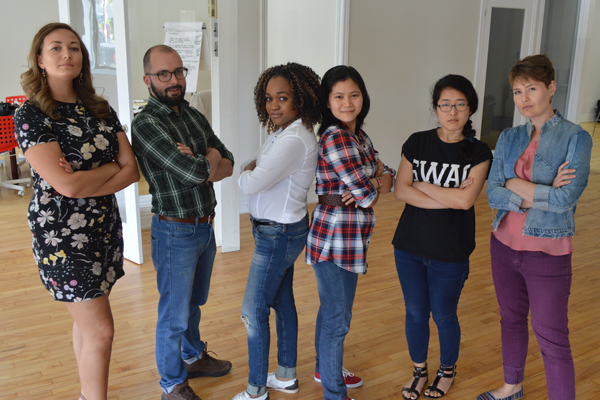 4 women and 1 man standing and facing the camera