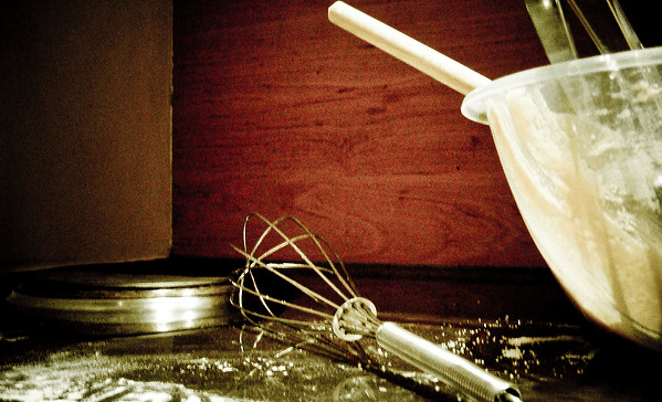 Flour on counter, with whisk and bowl