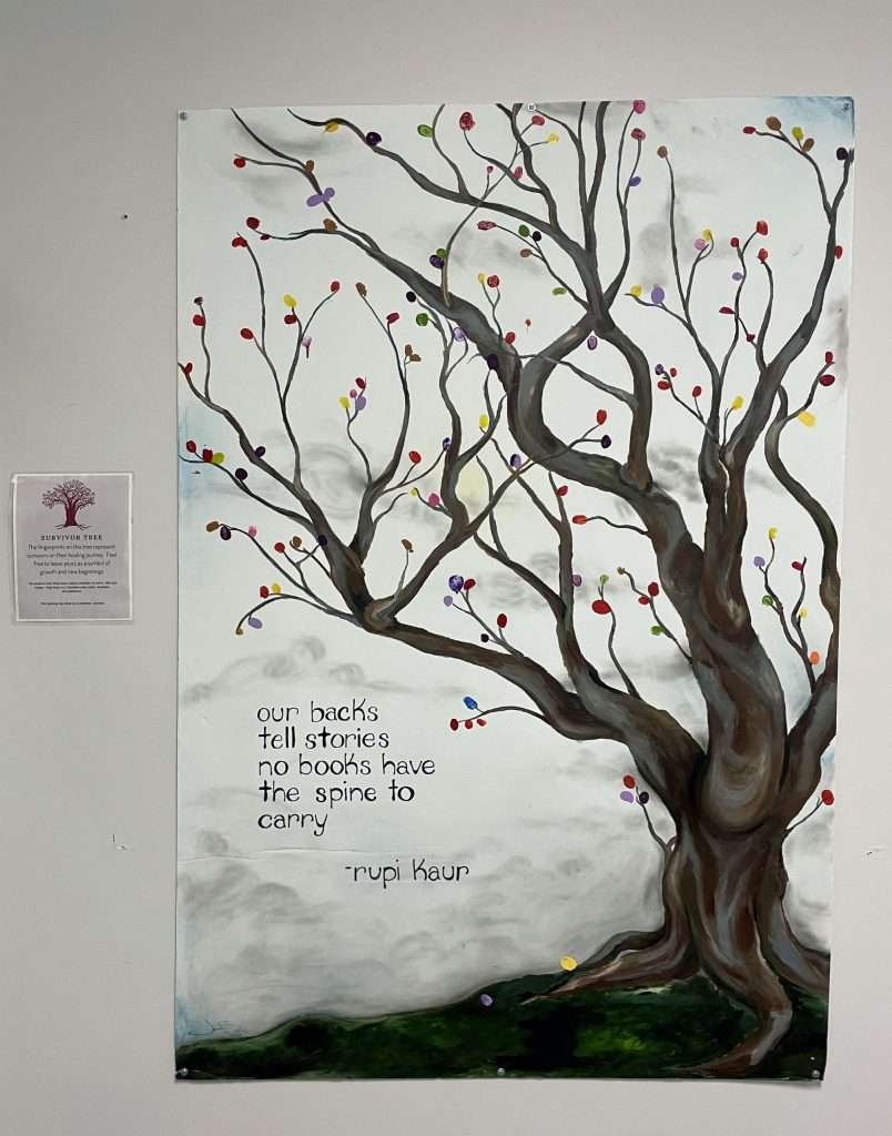 Photo of a painting that shows a tree with a poem beside it